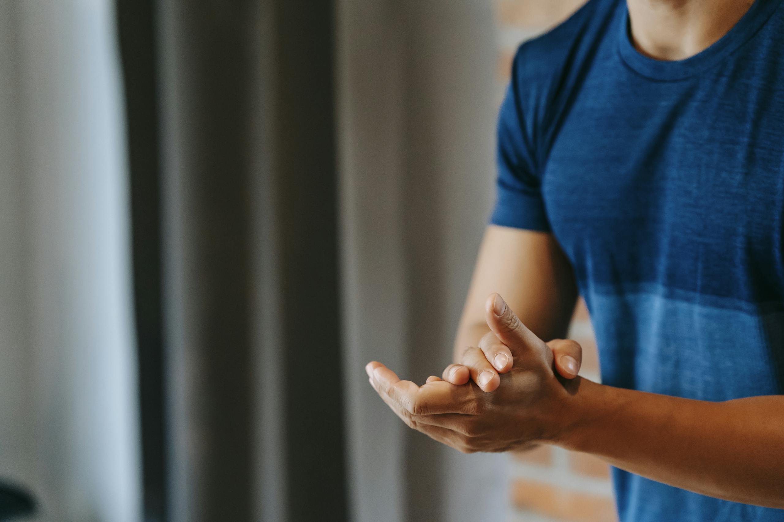 Crop unrecognizable male in t shirt clapping hands for encourage and support in sports club