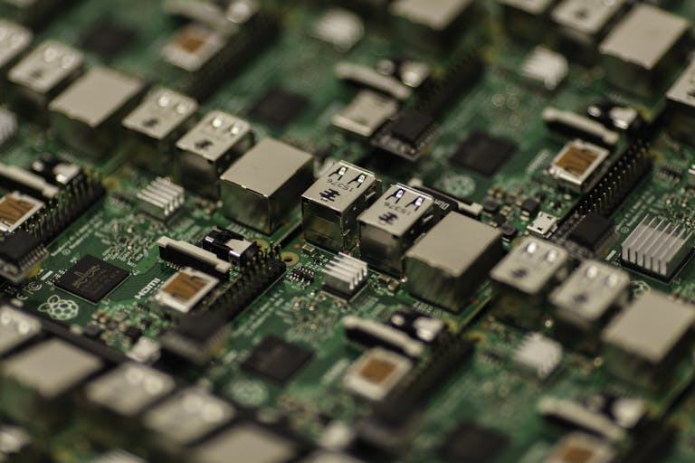 Detailed shot of a Raspberry Pi circuit board showcasing its components, USB ports, and microchips.